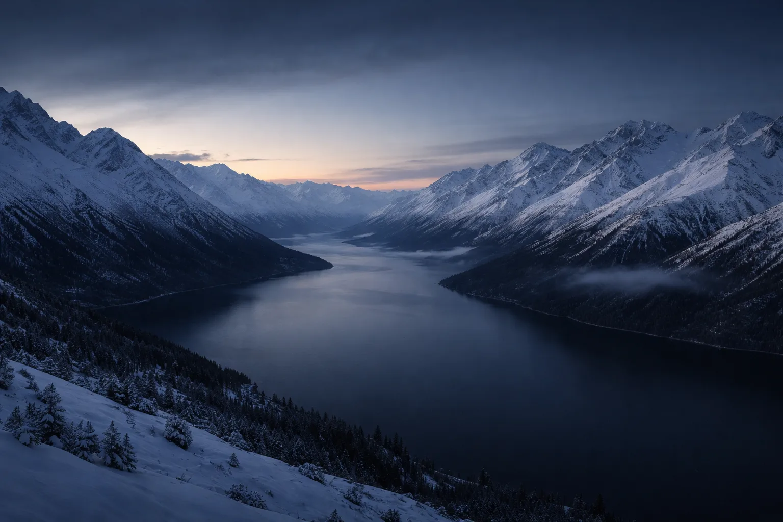 Calm fjord between snow mountains at dusk with warm horizon glow